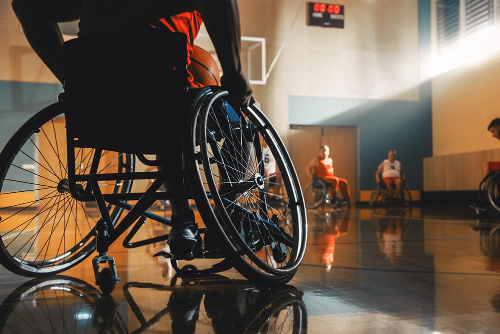 Wheelchair basketball player watching game on court.